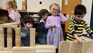 Kids playing with wooden building blocks