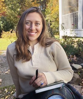 Bethany smiles before fall foliage in the background